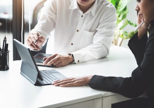 Two young business executives are discussing to change their business concept to increase profits and the strength of their business